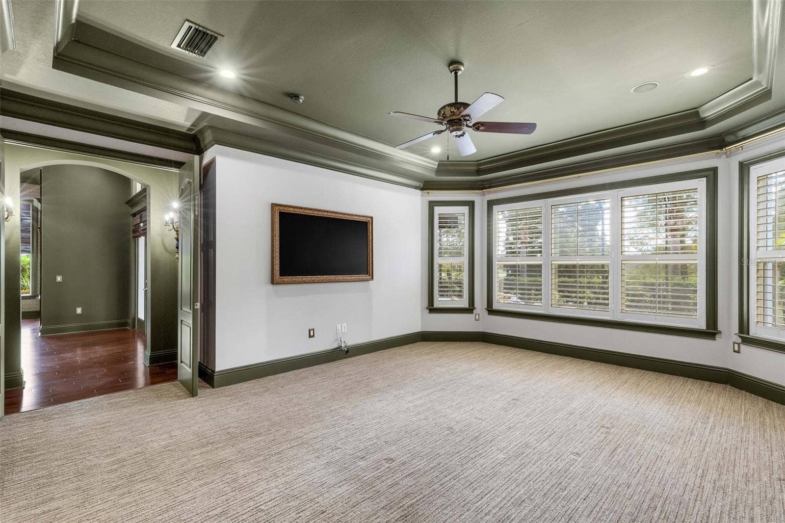 2734 BELLERIVE DRIVE, Lakeland, FL 33803 The sellers have opted to leave the framed wall mounted TV that provides a touch of elegance that the standard big screen can't come close to duplicating.