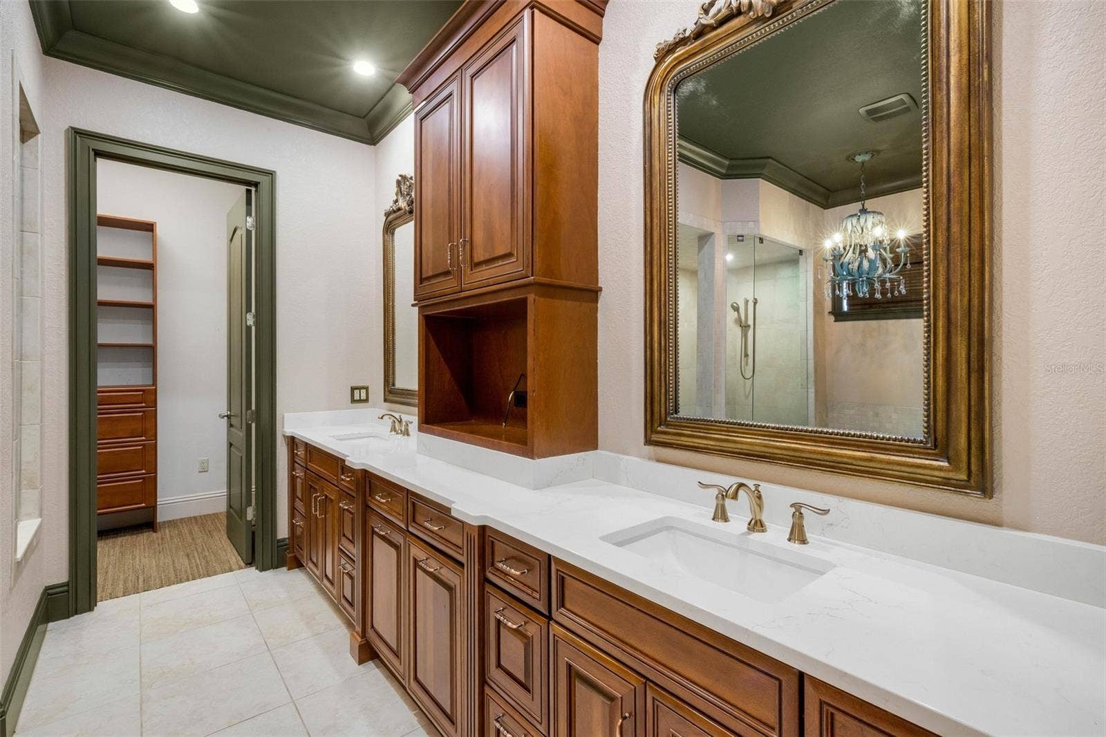 2734 BELLERIVE DRIVE, Lakeland, FL 33803 The ensuite bathroom features a long-split vanity with central tower for added storage.