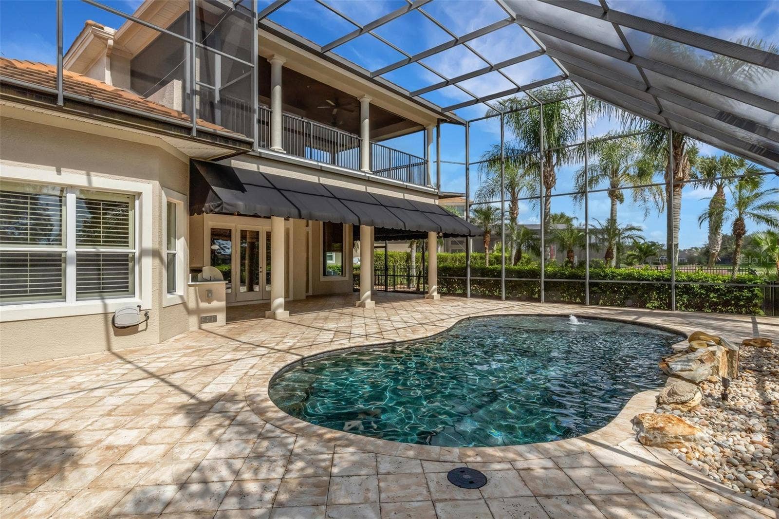 2734 BELLERIVE DRIVE, Lakeland, FL 33803 Lagoon inspired pool complete with beach area and rock water feature.