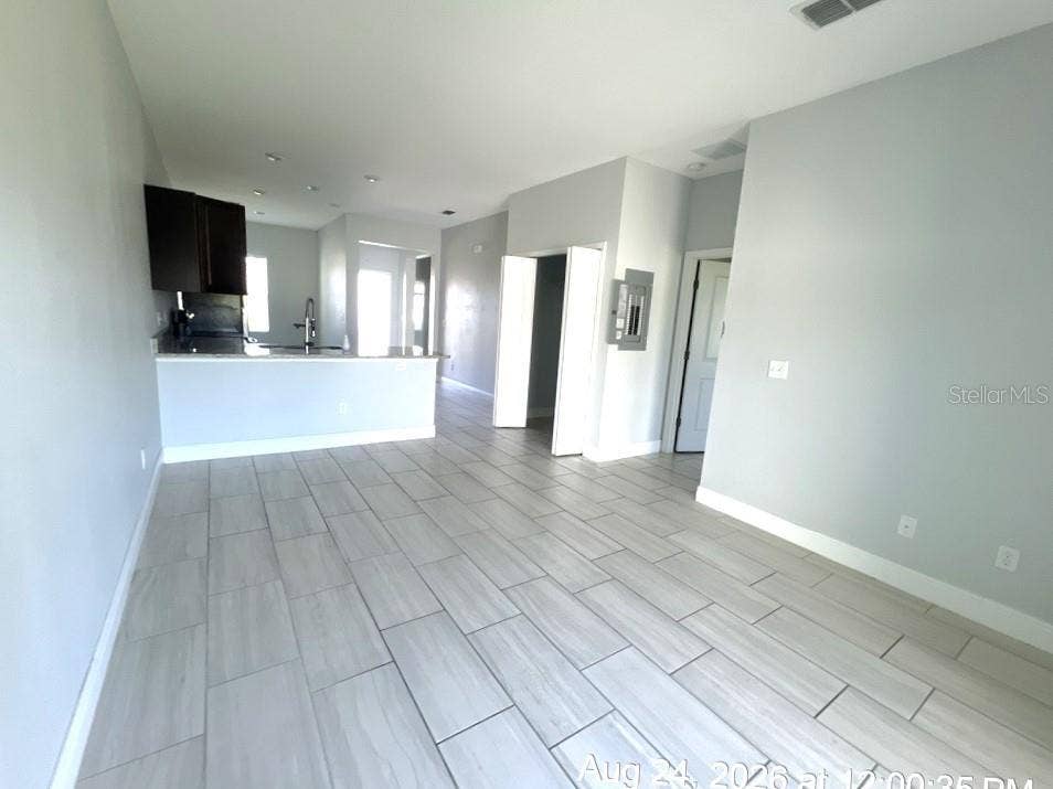 625 BITTERN COURT, #A & B, Poinciana, FL 34759 Living Room/Kitchen Combo w/Laundry Closet