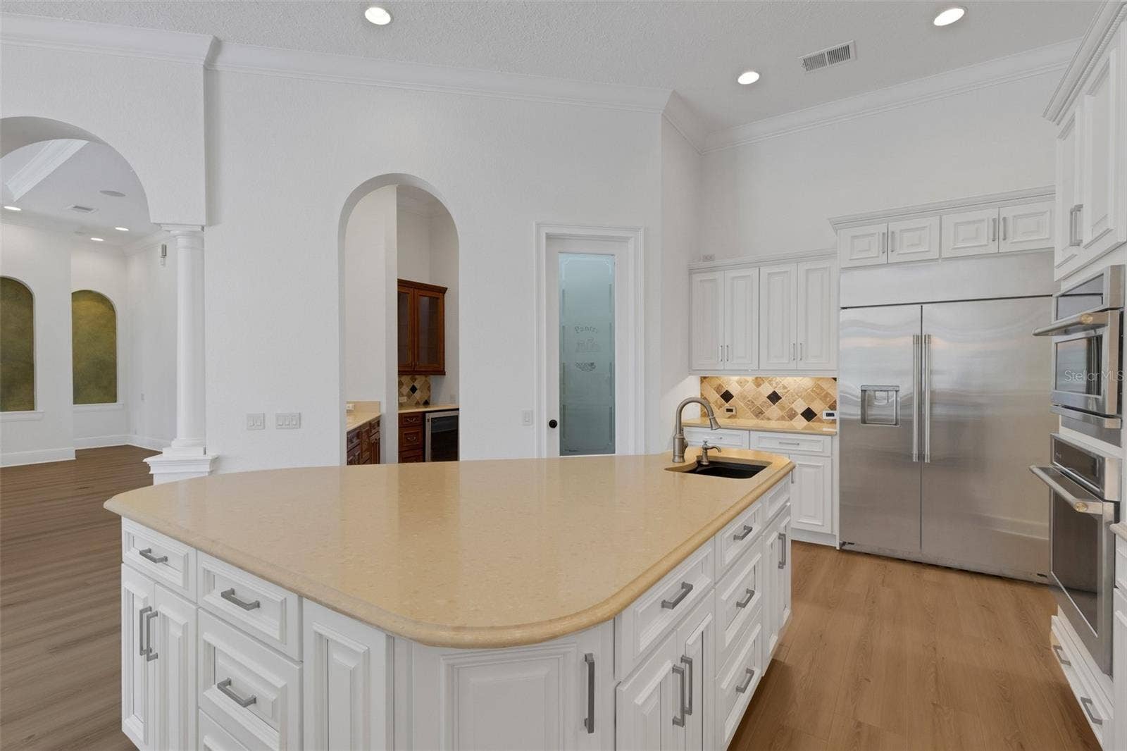 6562 EAGLE VIEW LOOP, Lakeland, FL 33813 a large central island with an additional prep-sink, walk-in pantry and butler's pantry & bar alcove.