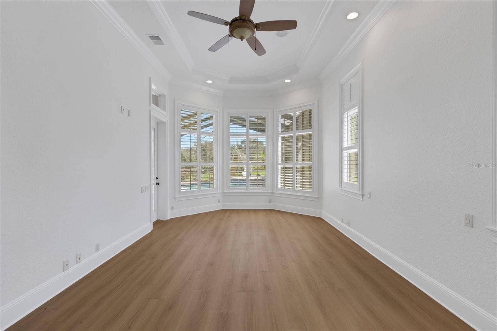 6562 EAGLE VIEW LOOP, Lakeland, FL 33813 designed for a sitting area that overlooks the pool and backyard beyond.