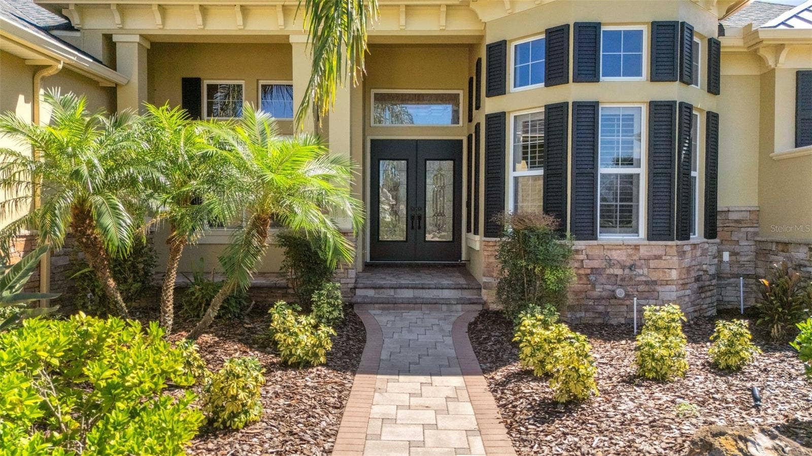 6562 EAGLE VIEW LOOP, Lakeland, FL 33813 The wide deep elevated entry boasts stone accents, brick pavers and dual leaded glass entry doors.
