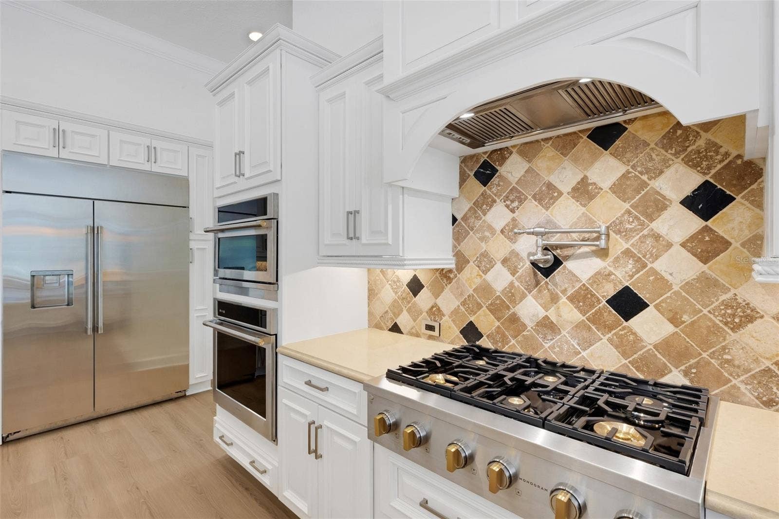 6562 EAGLE VIEW LOOP, Lakeland, FL 33813 The chef's kitchen features hi-end appliances that includes a 6-burner gas cooktop, oversized built-in refrigerator, built-in ovens and warming drawer . . .