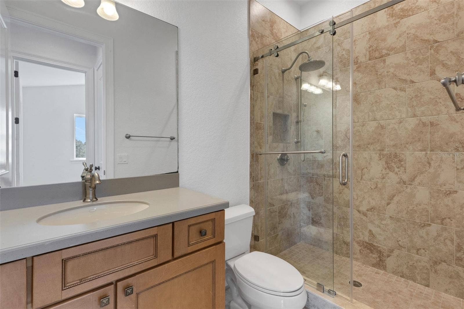 6562 EAGLE VIEW LOOP, Lakeland, FL 33813 Bathroom# 4 has a fully tiled shower with European glass enclosure system.