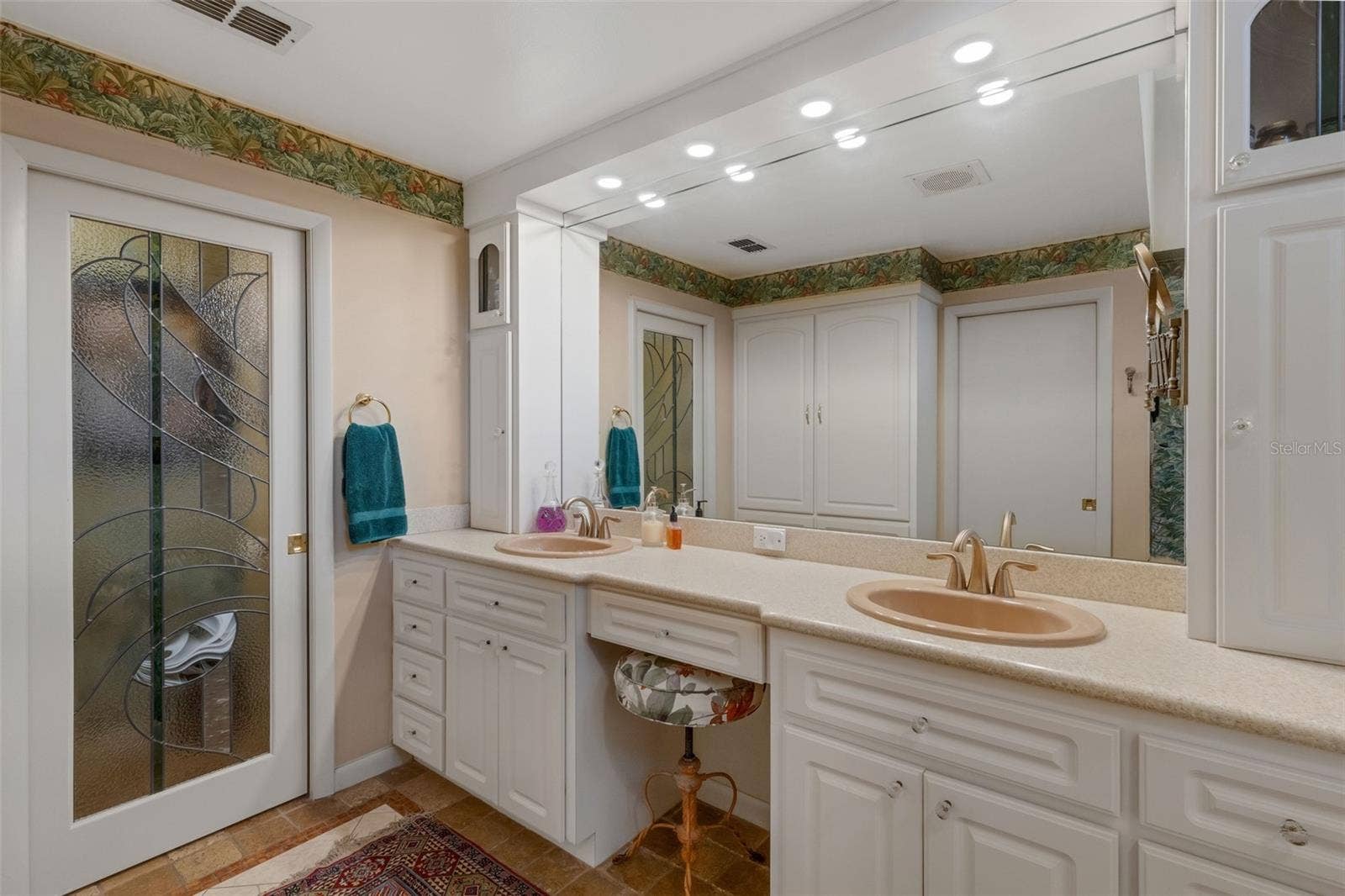 3507 BARLEY LANE, Lakeland, FL 33803 The ensuite bathroom features a long dual sink vanity with sitdown makeup area and tower storage at either end.
