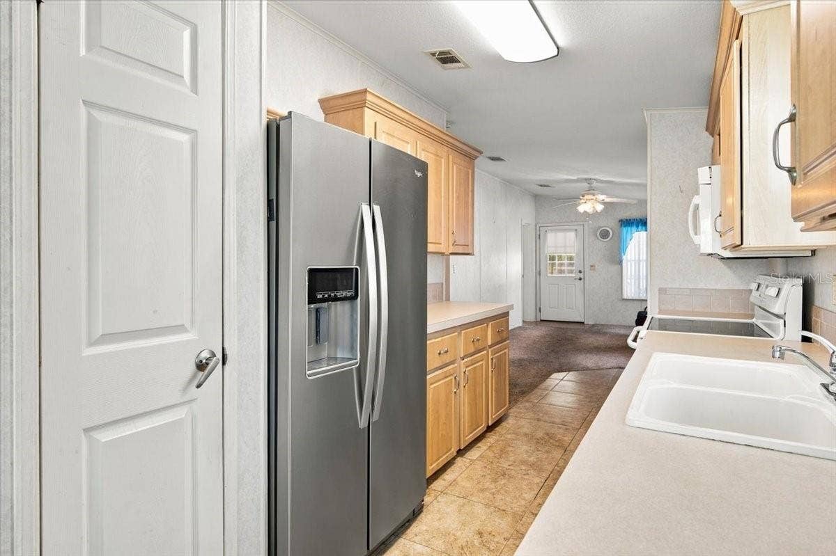 59 BEAVERKILL DRIVE, Lake Wales, FL 33898 Galley Kitchen with Stainless Fridge