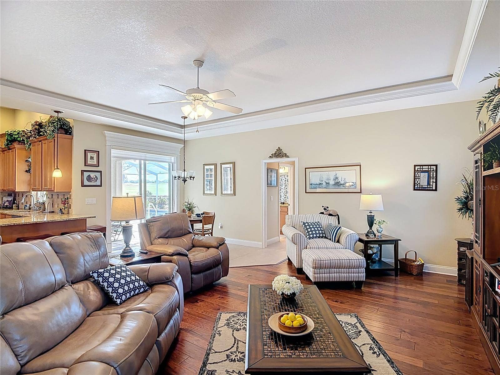 Sliders in family room open to pool at casual dining area