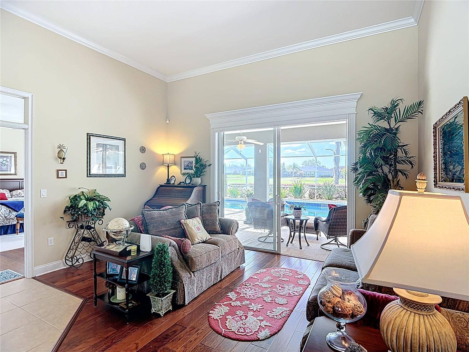 Formal Living room with views of pool and golf course.  All pictures with furniture taken while home was sill occupied.