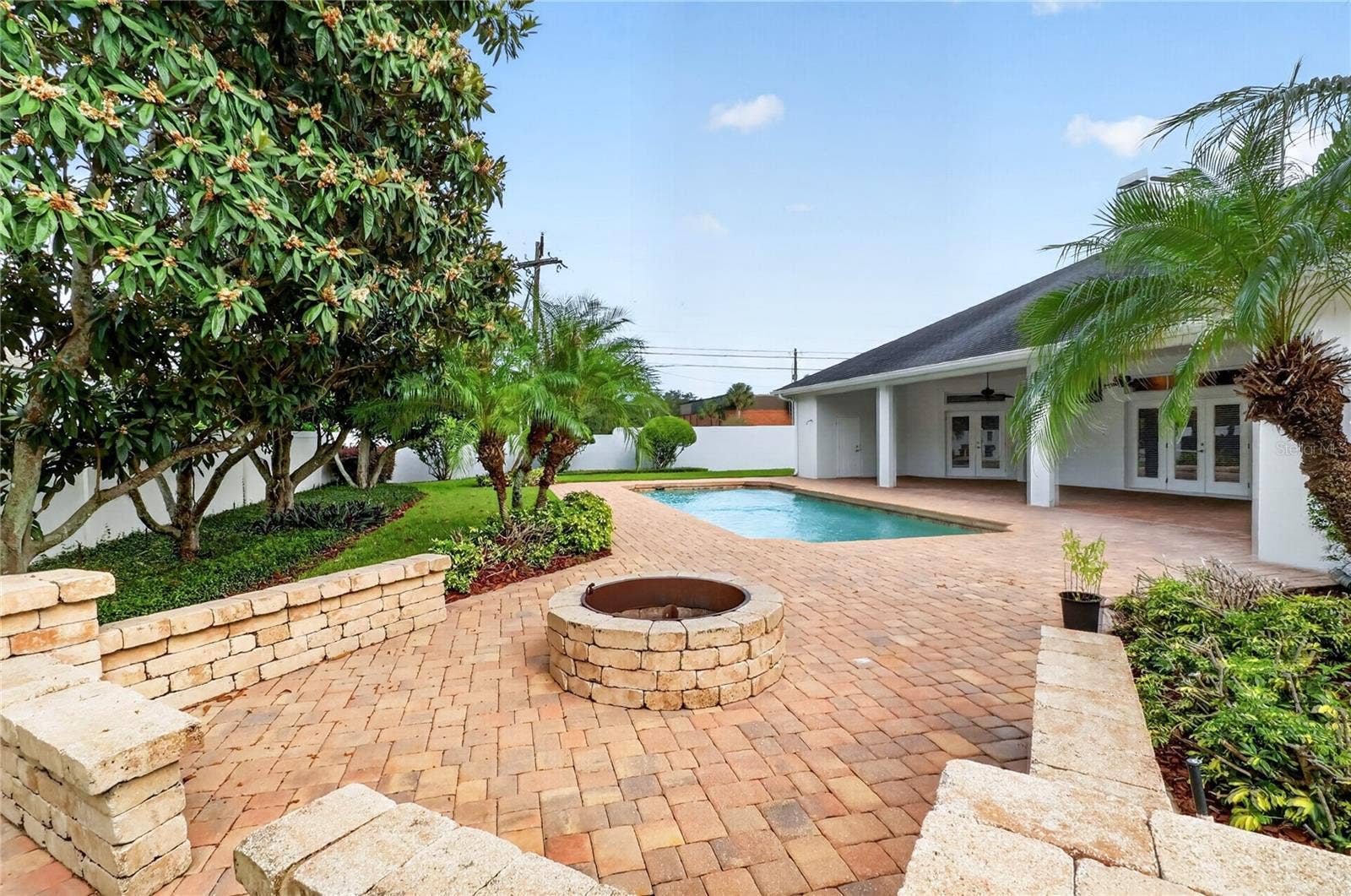 Backyard Fire Pit and wall overlooking the pool