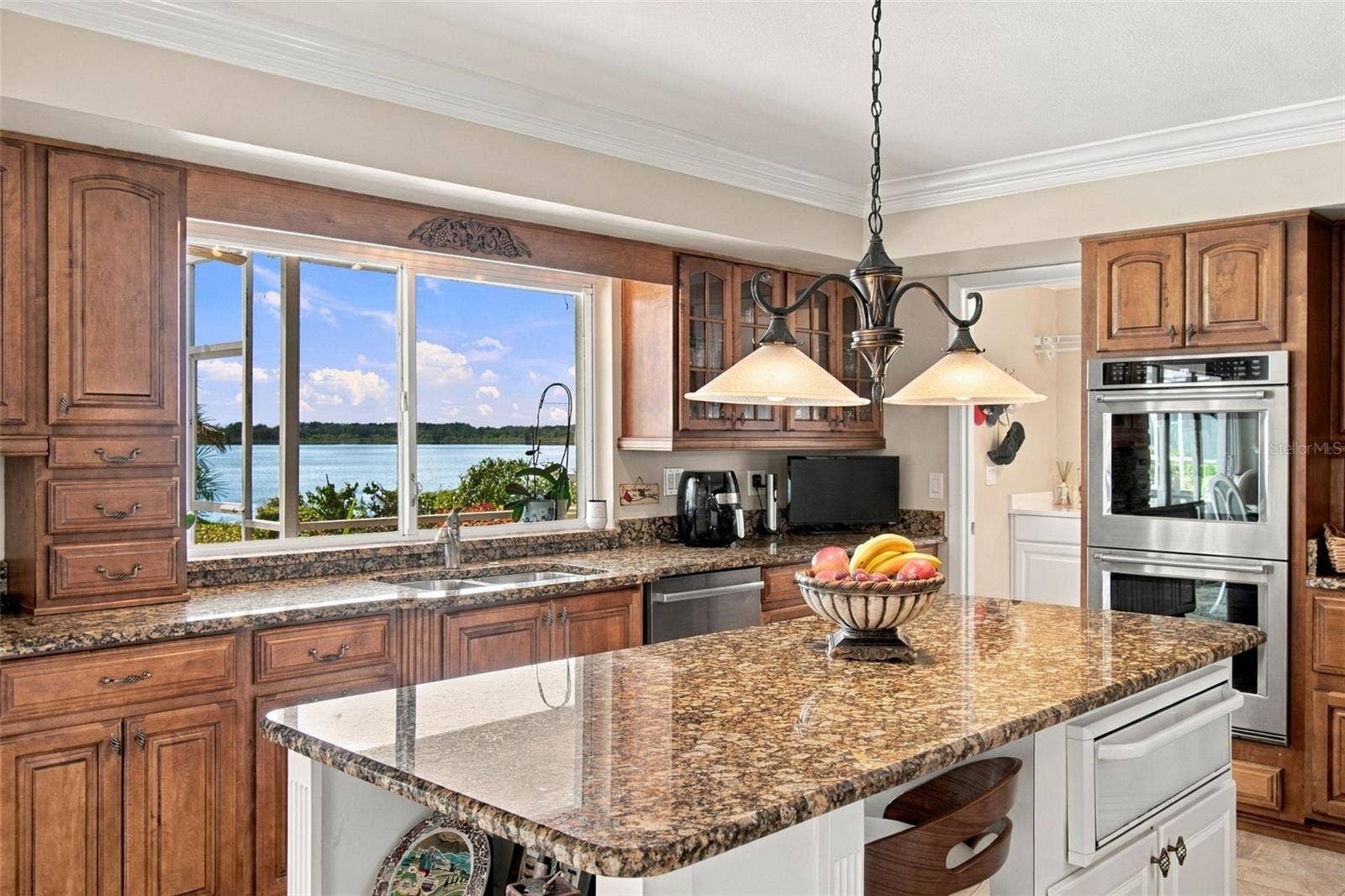 1921 MANOR CIRCLE SE, Winter Haven, FL 33880 Lakeview kitchen - Pendant lighting & pass through window to outside bar