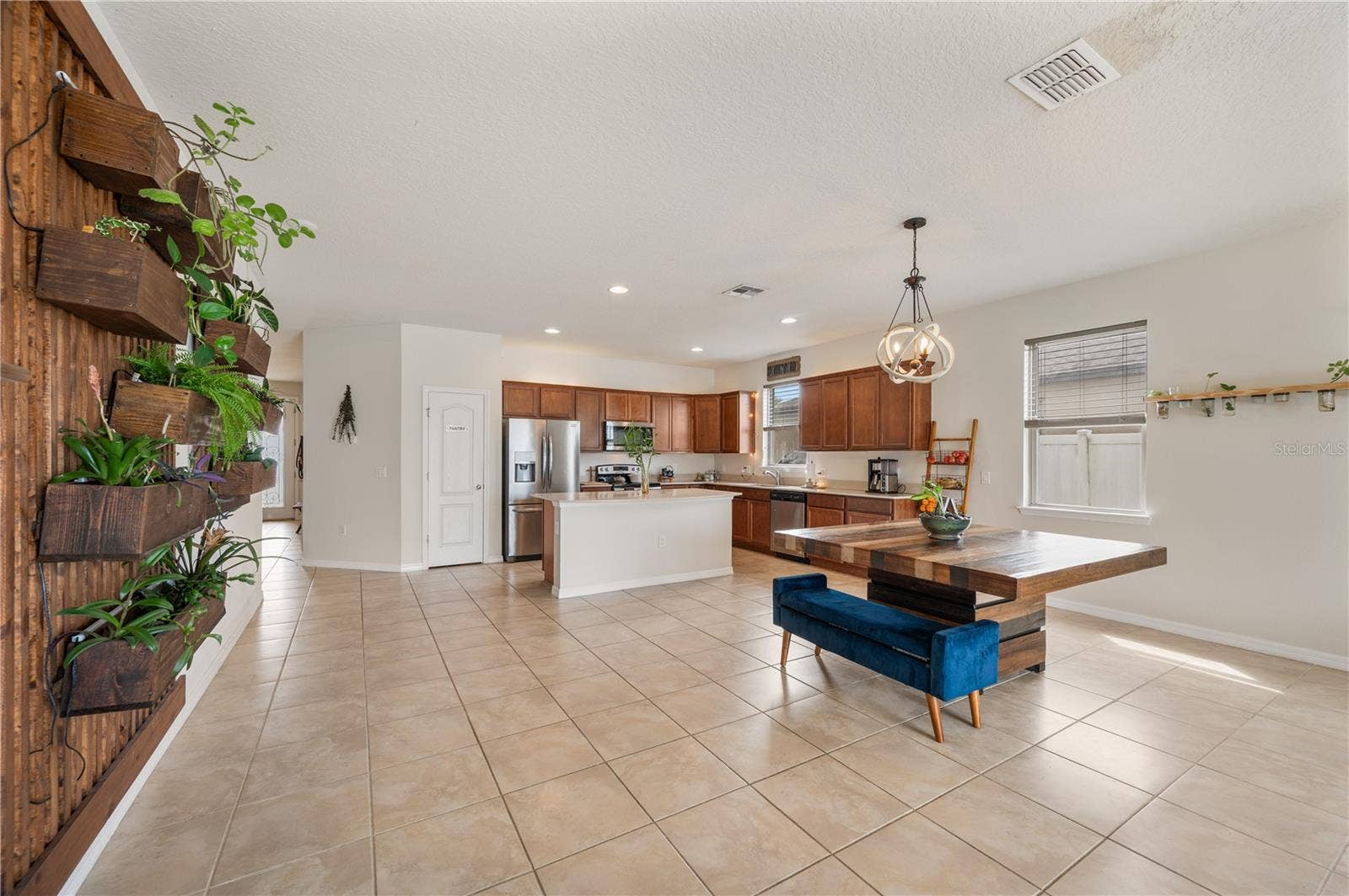 8751 RINDGE ROAD, Polk City, FL 33868 Open Floor Plan / Kitchen / Dining Room / Living Room / Live Plant Wall