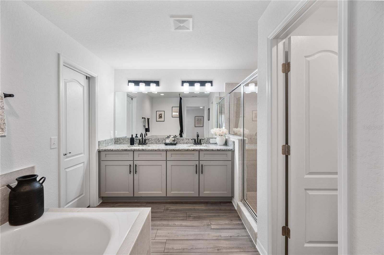 1279 PINTAIL PLACE, Lakeland, FL 33813 The Primary en suite bathroom features a large walk in closet, walk-in shower, soaking tub & private commode area & oversized dual sinks vanity