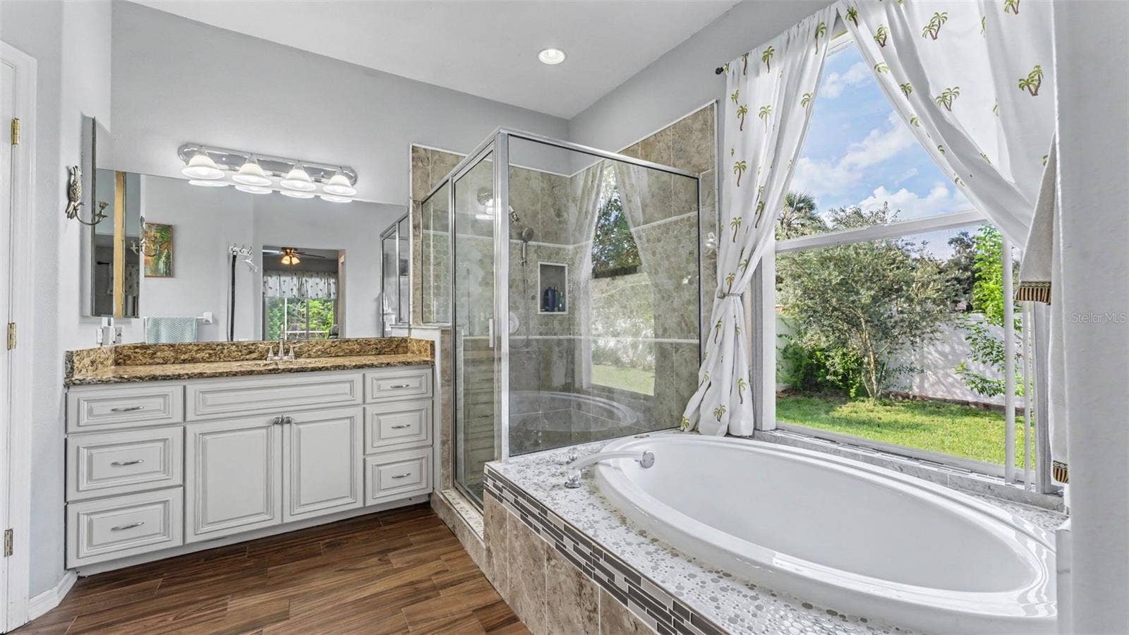 6626 ROYAL FOREST DR, Lakeland, FL 33811 Beautiful remodeled ensuite bathroom with soaking tub, walk-in shower, double vanities, and private toilet room