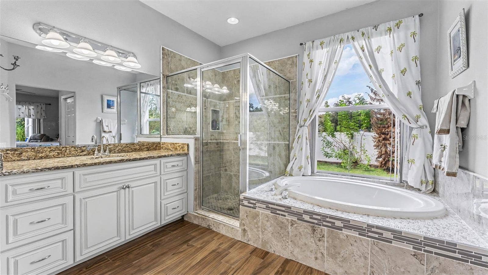 6626 ROYAL FOREST DR, Lakeland, FL 33811 Beautiful remodeled ensuite bathroom with soaking tub, walk-in shower, double vanities, and private toilet room