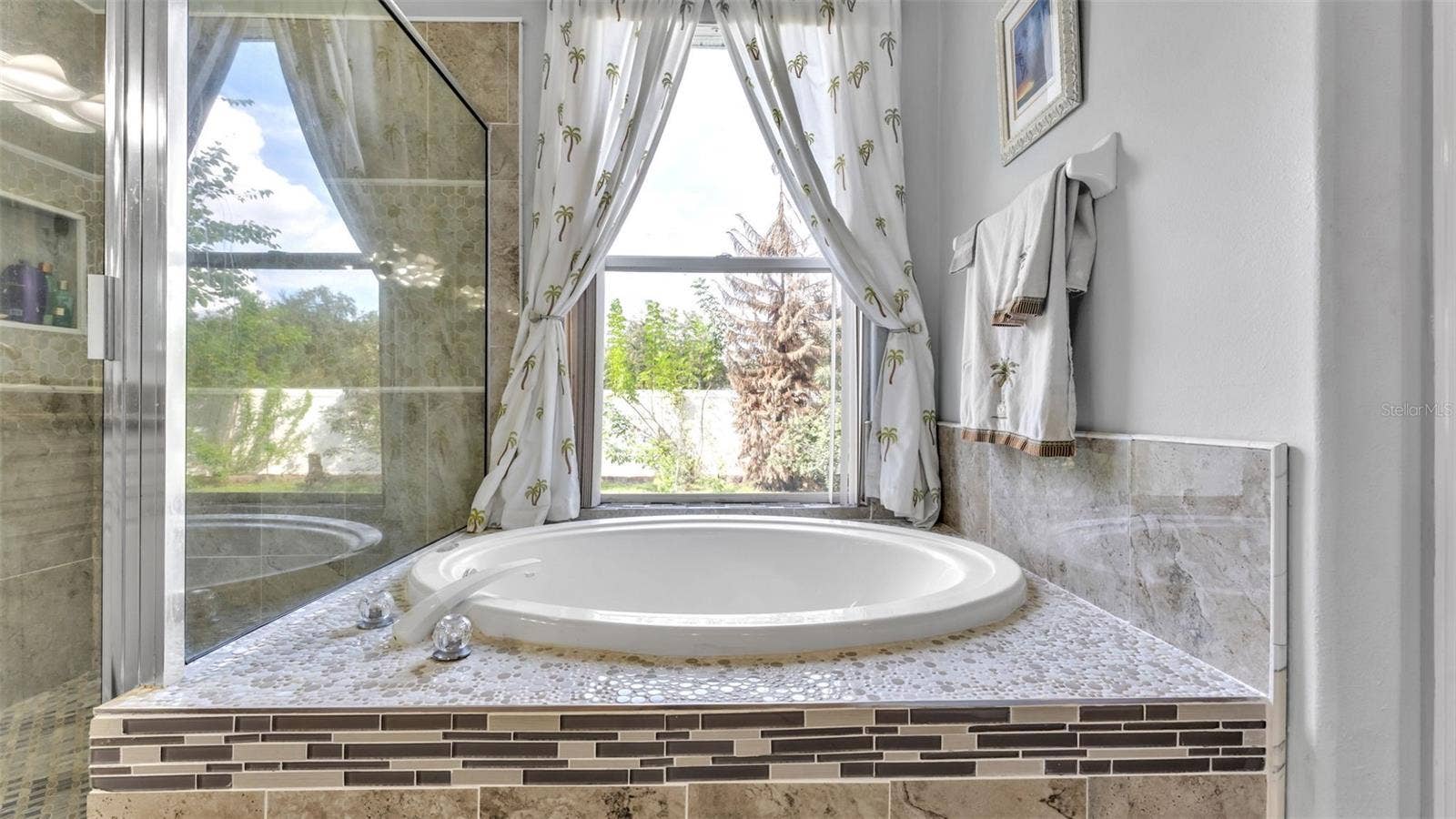 6626 ROYAL FOREST DR, Lakeland, FL 33811 Beautiful remodeled ensuite bathroom with soaking tub, walk-in shower, double vanities, and private toilet room
