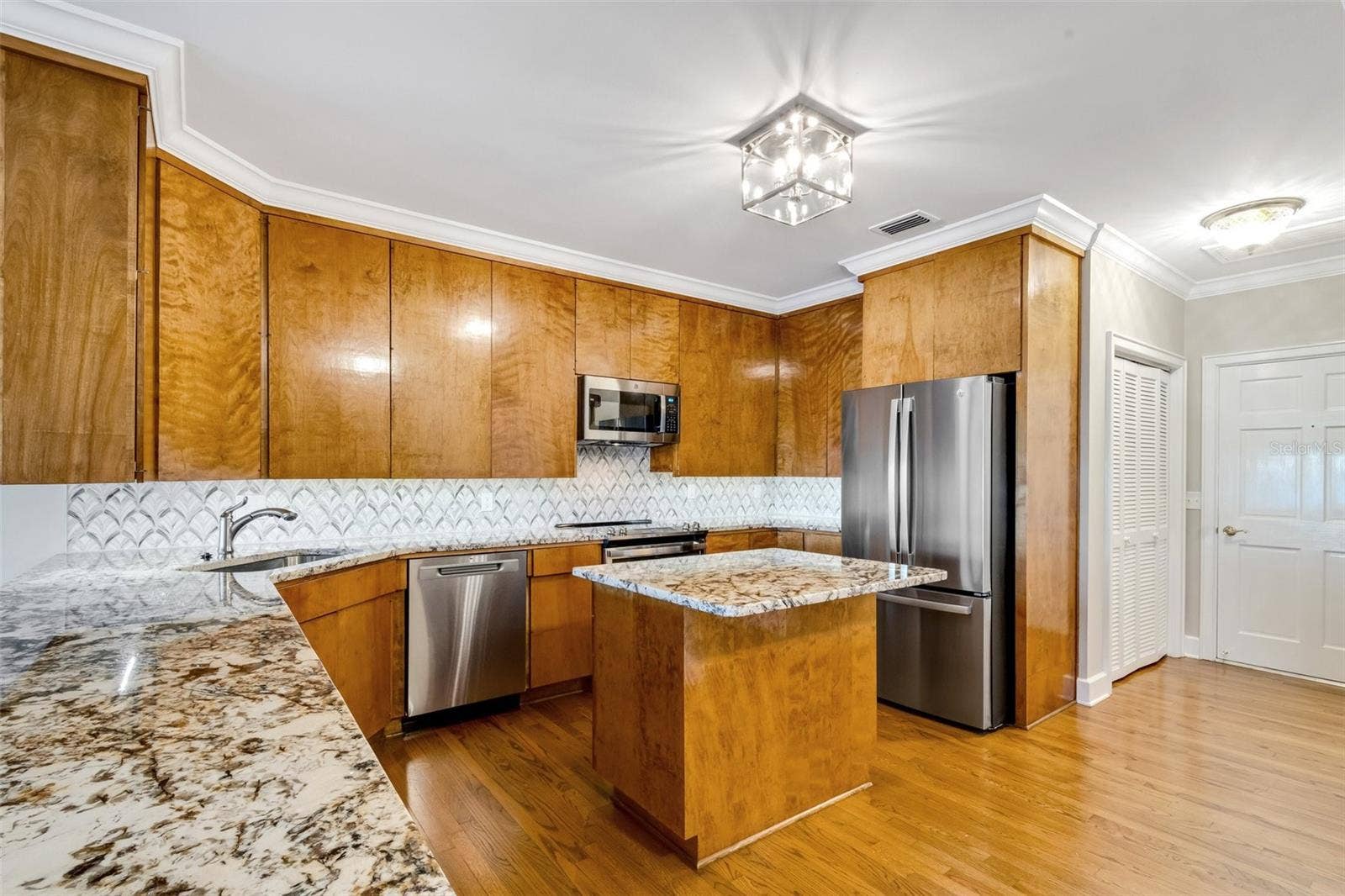 155 LAKE MORTON DRIVE, #2, Lakeland, FL 33801 The kitchen is well appointed, newer stainless appliances , including a separate ice maker , dishwasher, microwave, dishwasher .