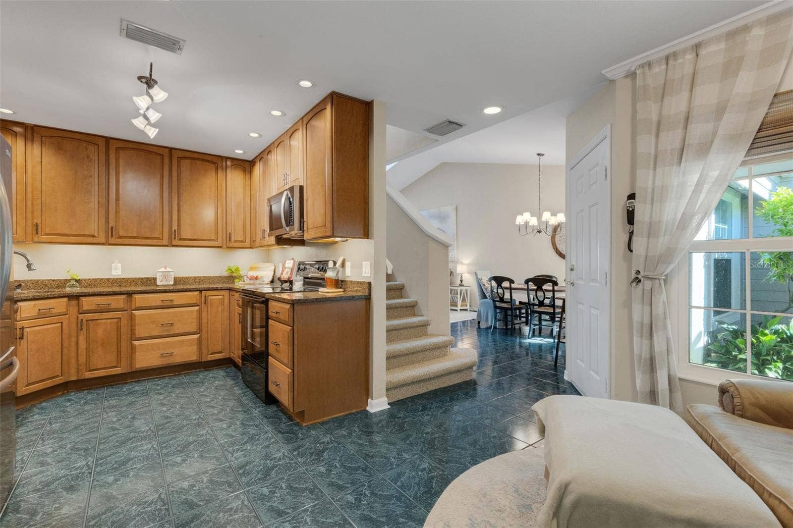 1113 WATERFALL LANE, Lakeland, FL 33803 The kitchen boasts wood cabinets and granite countertops.