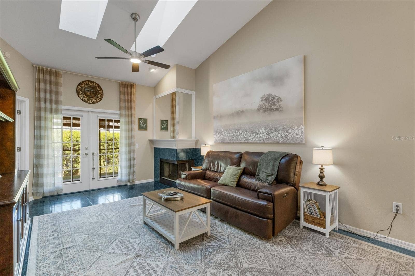 1113 WATERFALL LANE, Lakeland, FL 33803 Neutral color palette brightened by two skylights overhead in the vaulted ceiling of the space.