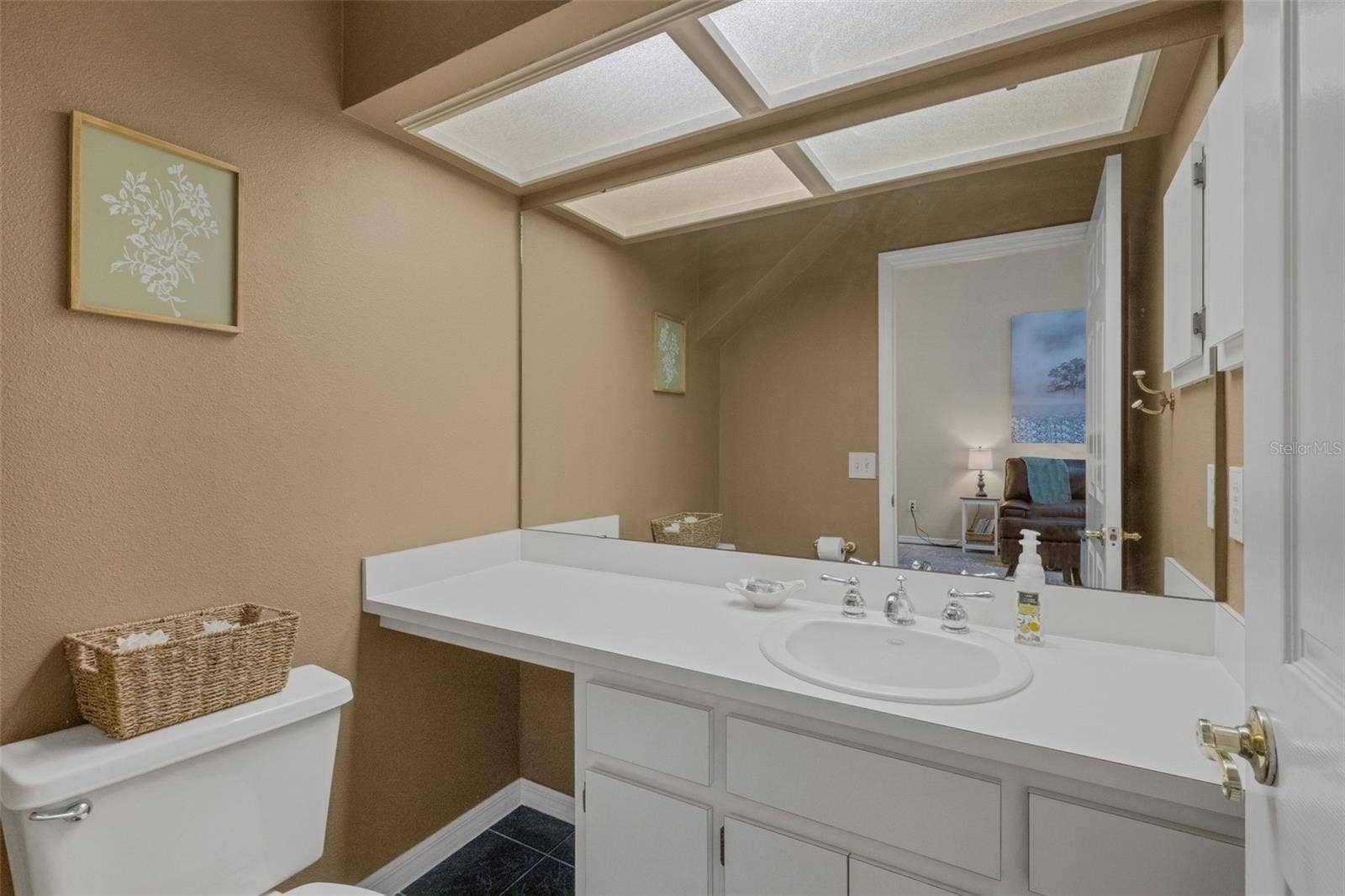 1113 WATERFALL LANE, Lakeland, FL 33803 Tucked into an alcove under the stairs is the guest powder room.