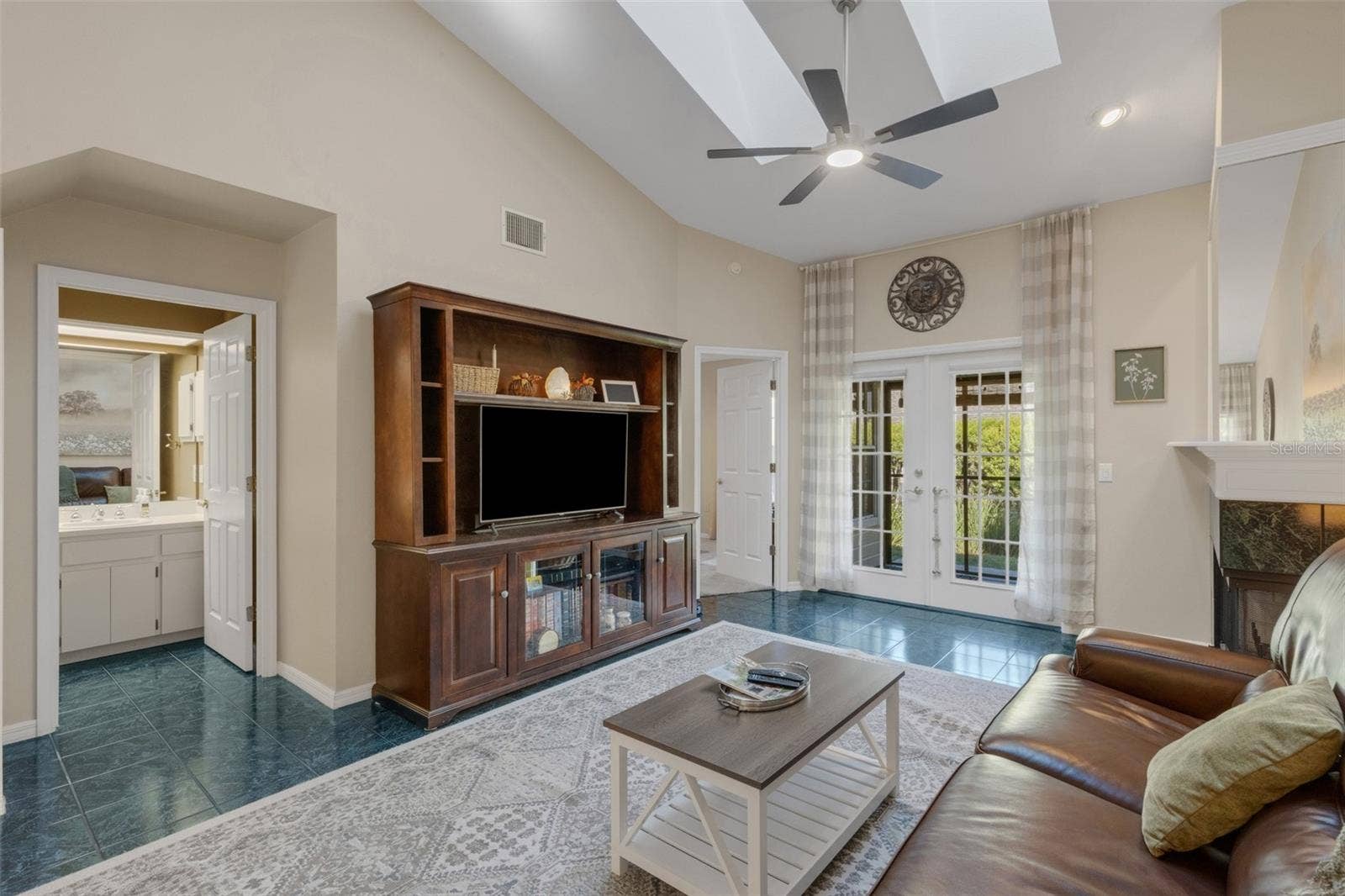 1113 WATERFALL LANE, Lakeland, FL 33803 French doors lead to the covered screen enclosed lanai.