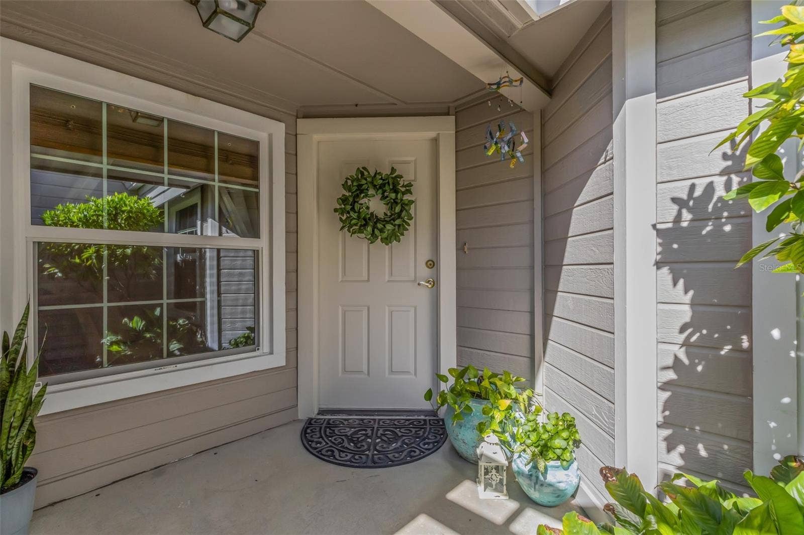 1113 WATERFALL LANE, Lakeland, FL 33803 Private covered entrance will always make family and friends feel welcome.