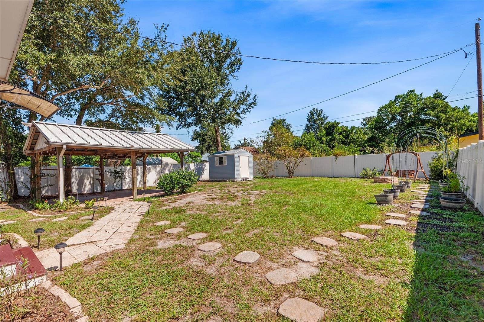 807 INTERLACHEN PARKWAY, Lakeland, FL 33801 Firepit view with shed and stepping stones