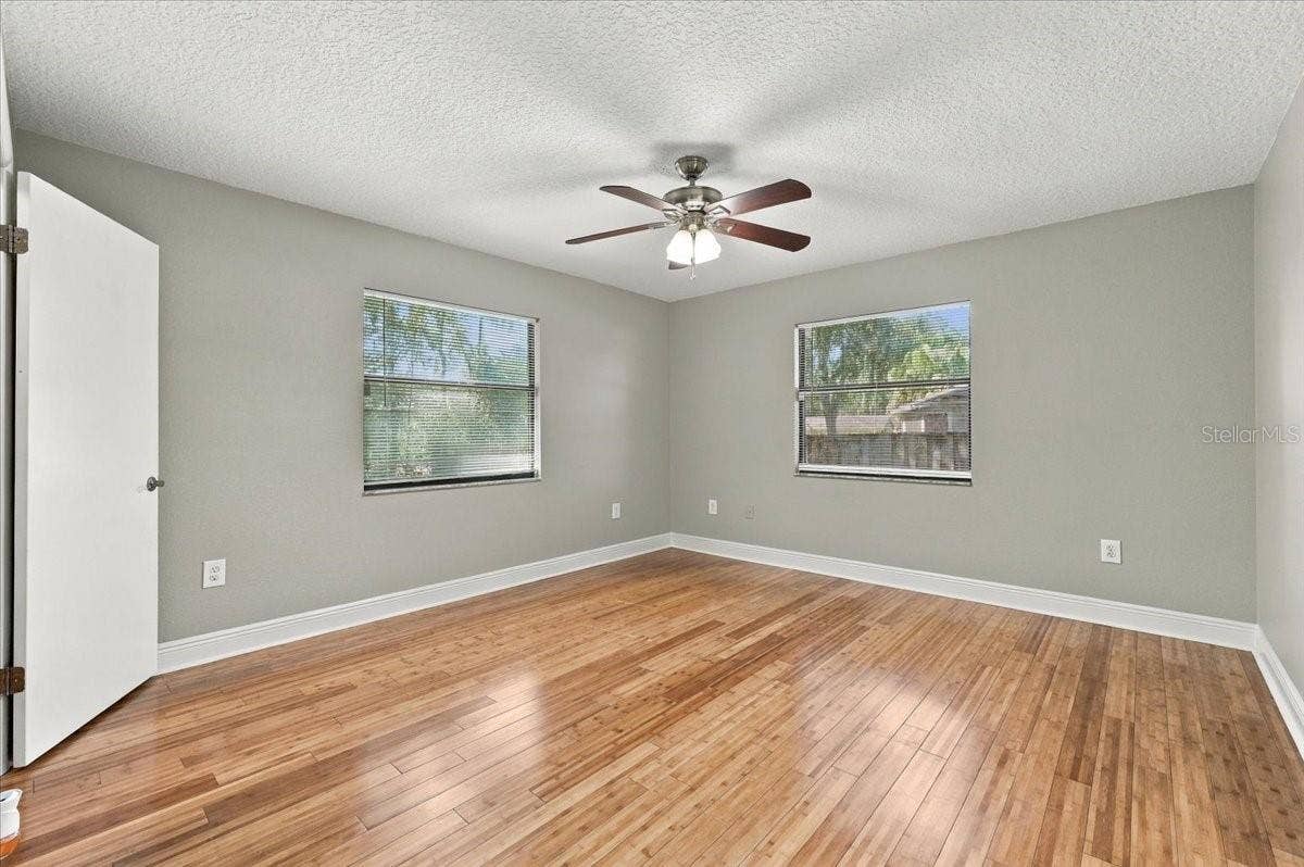 5244 QUIET CREEK LANE, Lakeland, FL 33811 Primary bedroom is split from the other bedrooms, ceiling fan, walk in closet, new blinds and bamboo hardwood flooring.