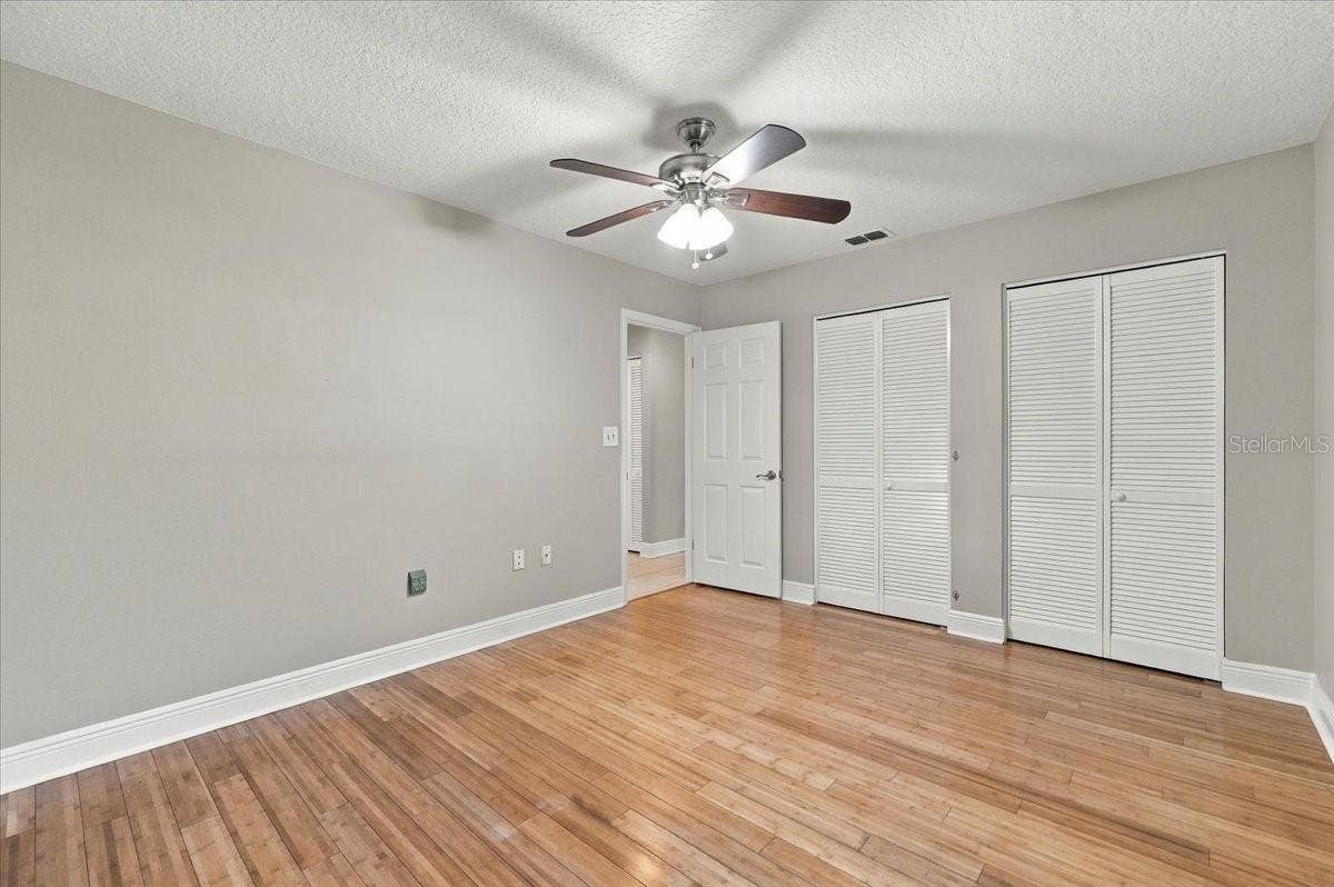 5244 QUIET CREEK LANE, Lakeland, FL 33811 2nd bedroom with double closets, ceiling fan, new blinds and bamboo hardwood flooring.