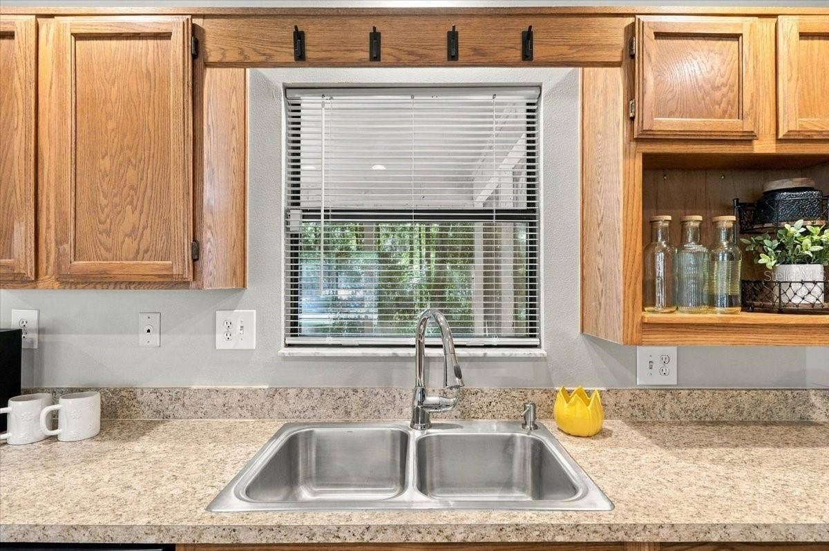 5244 QUIET CREEK LANE, Lakeland, FL 33811 Kitchen window has a bar to the porch. Wash the dishes with a view!