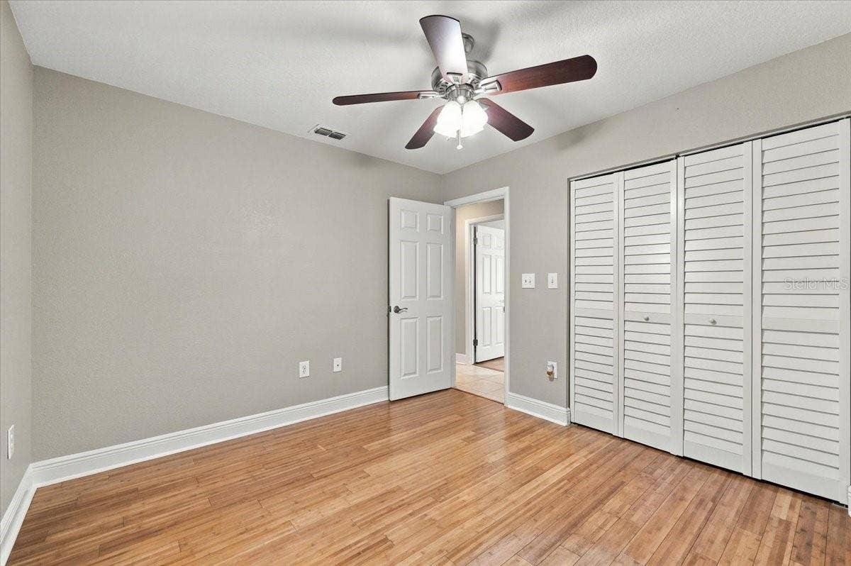 5244 QUIET CREEK LANE, Lakeland, FL 33811 3rd bedroom with ceiling fan, new blinds and bamboo hardwood flooring.