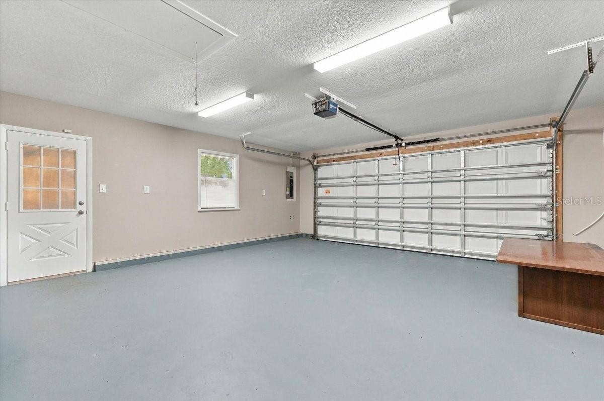 5244 QUIET CREEK LANE, Lakeland, FL 33811 2 car garage with service door and new impact garage door with opener.