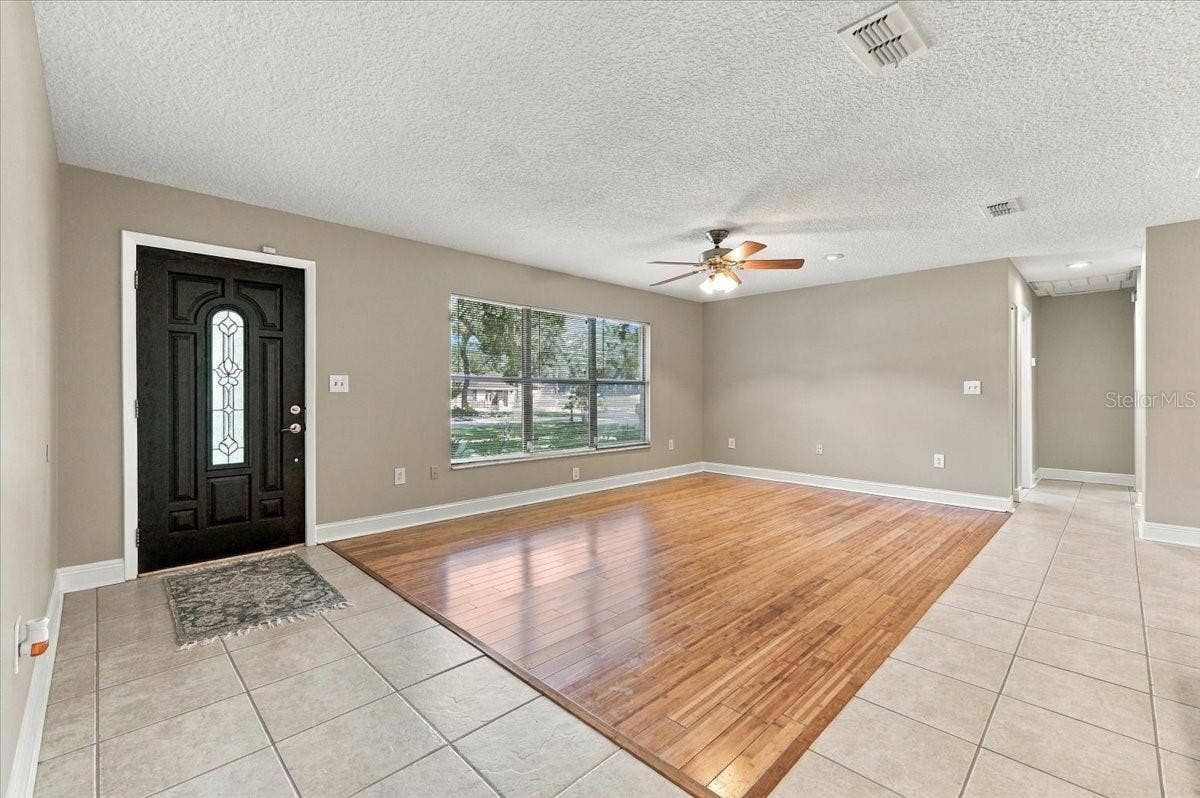 5244 QUIET CREEK LANE, Lakeland, FL 33811 Living area open to dining and kitchen.