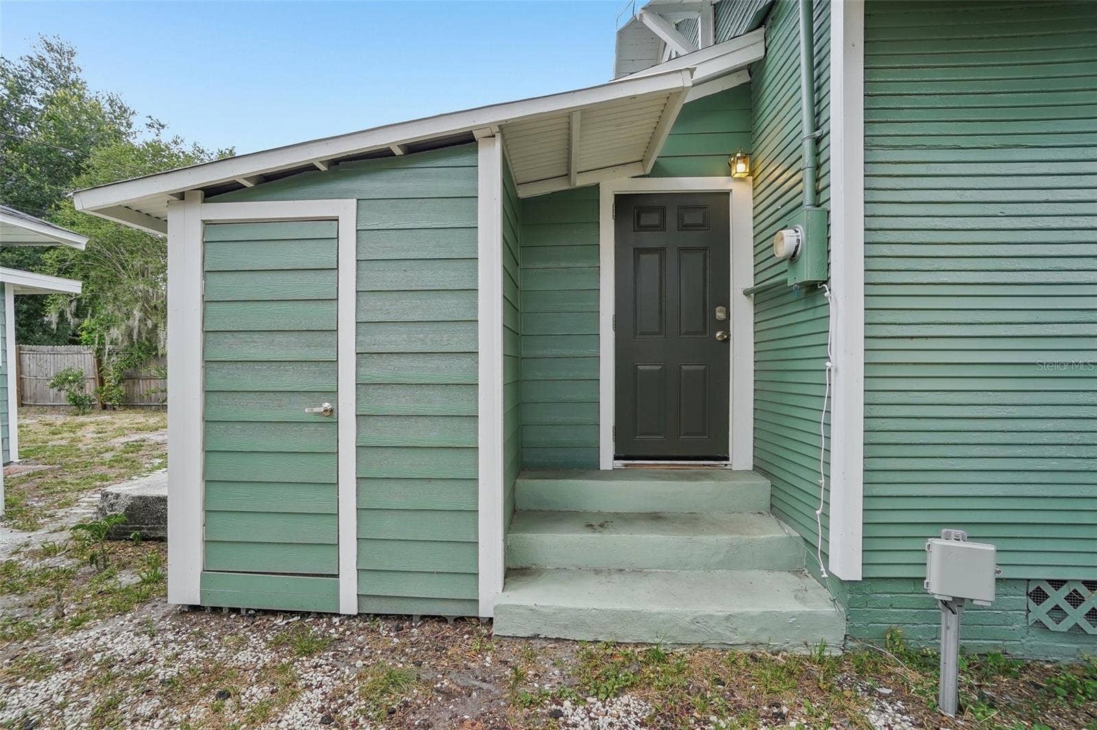 1533 E ELM ROAD, Lakeland, FL 33801 Main House Exterior- Side Door and Storage Closet