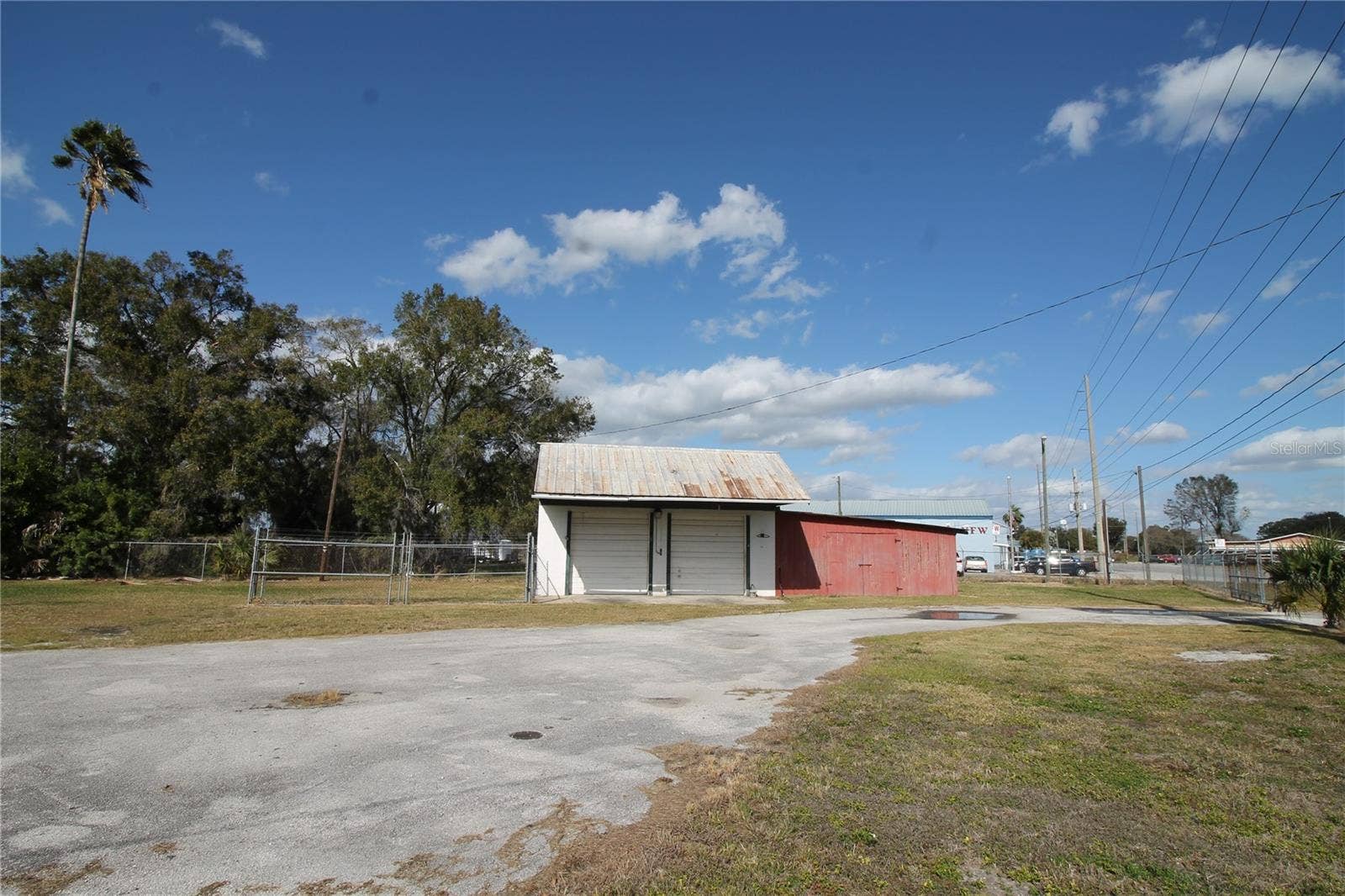 2545 7TH STREET SW, Winter Haven, FL 33880 Two Bay garage with over sized Doors, the red portion will be retained by the owner for their personal supplies.