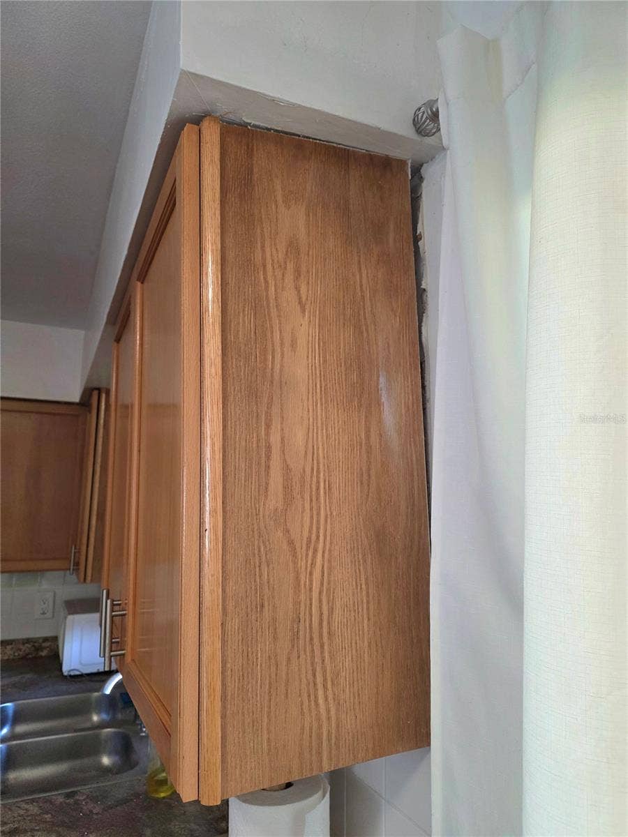 1920 E EDGEWOOD DRIVE, #A3, Lakeland, FL 33803 Slight separation of cabinet from wall