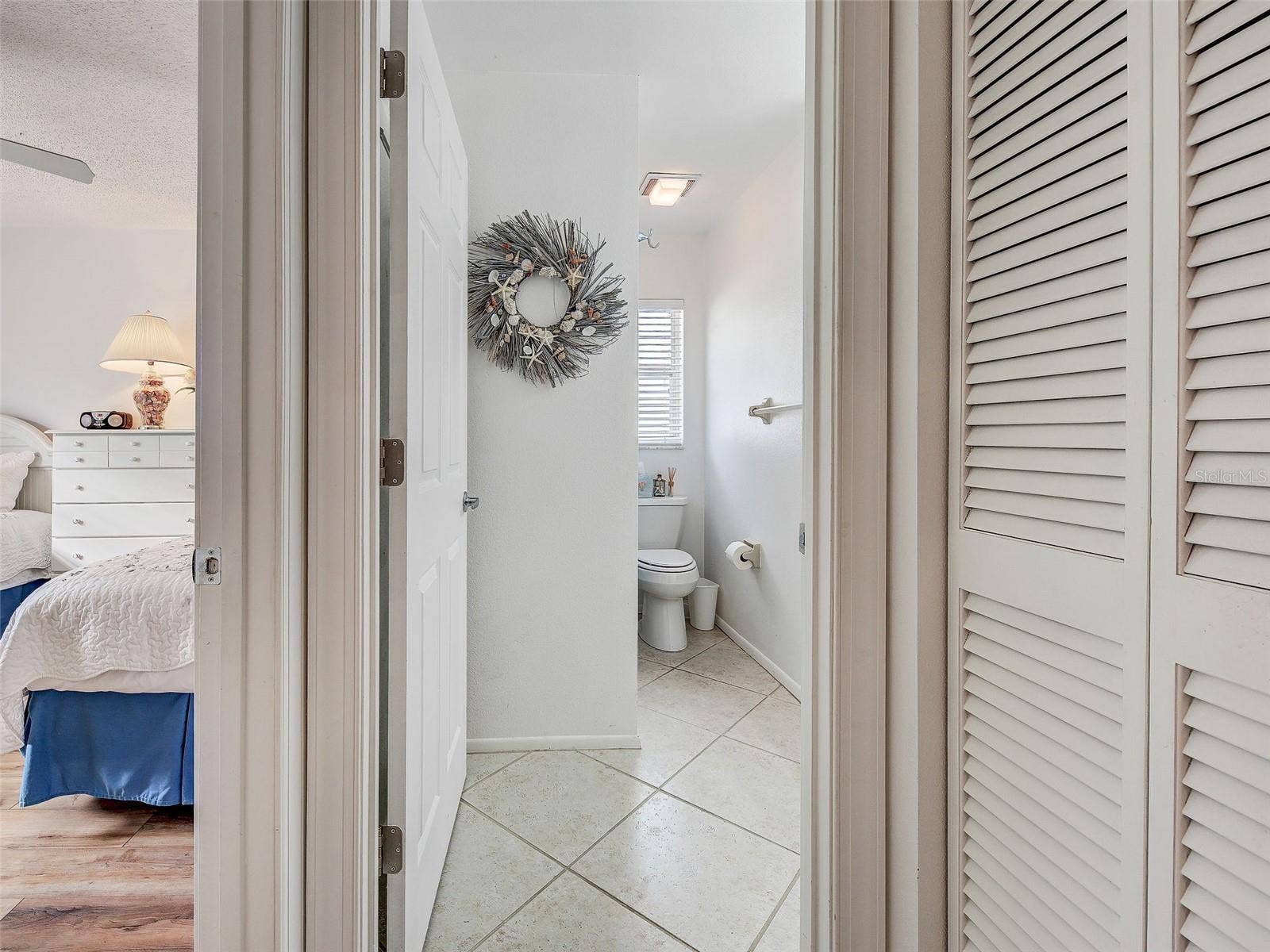 guest bath with shower/bathtub. Guest bedroom to the left