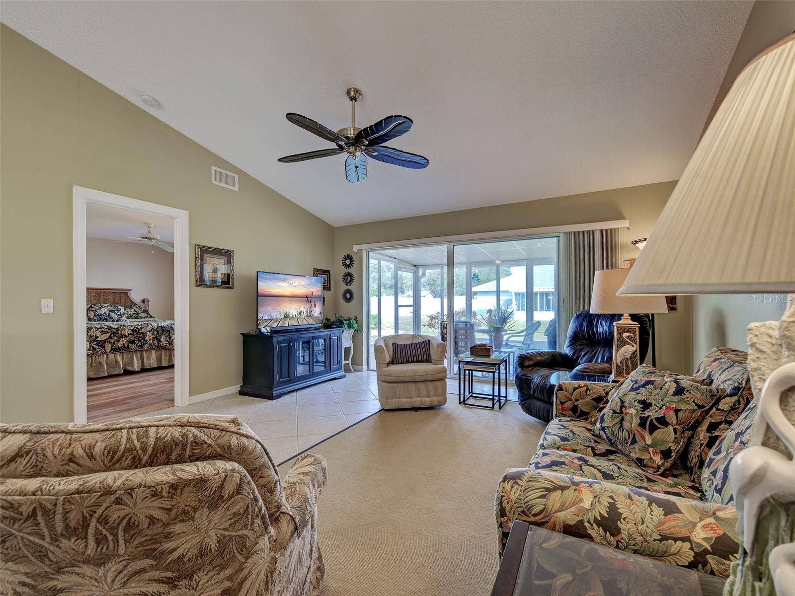 Picture taken from kitchen to show living room with primary bedroom to the left and SGD to the lanai. Villa comes fully turnkey furnished
