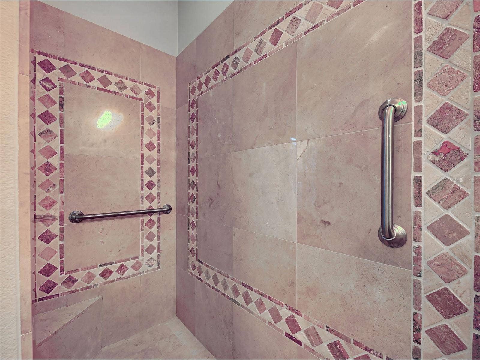 Large, tiled Roman slower with bench and grab bars.
