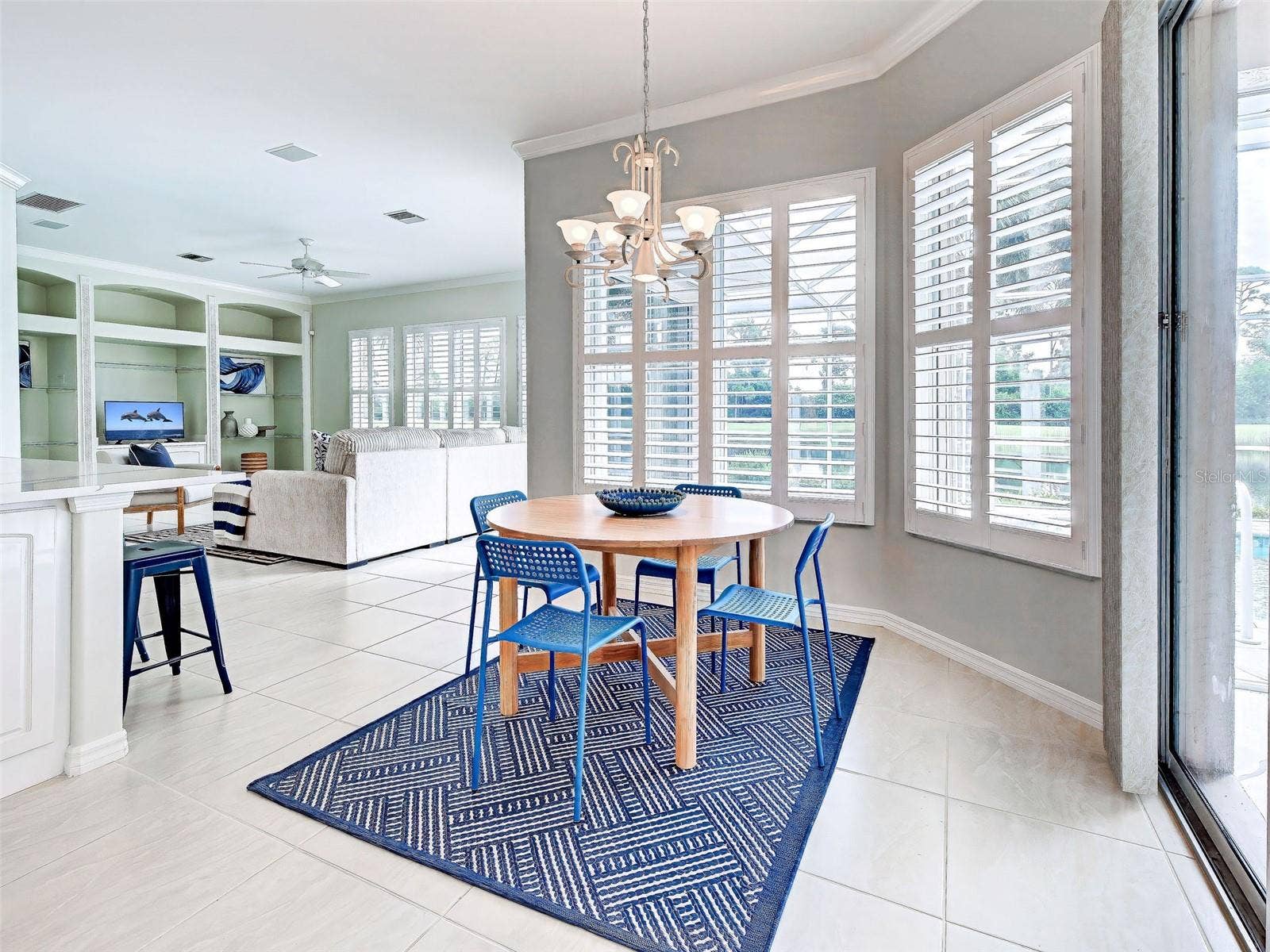 Kitchen area flows beautifully to the spacious family room.  Crown molding and plantation shutter throughout make this lovely home so classy.