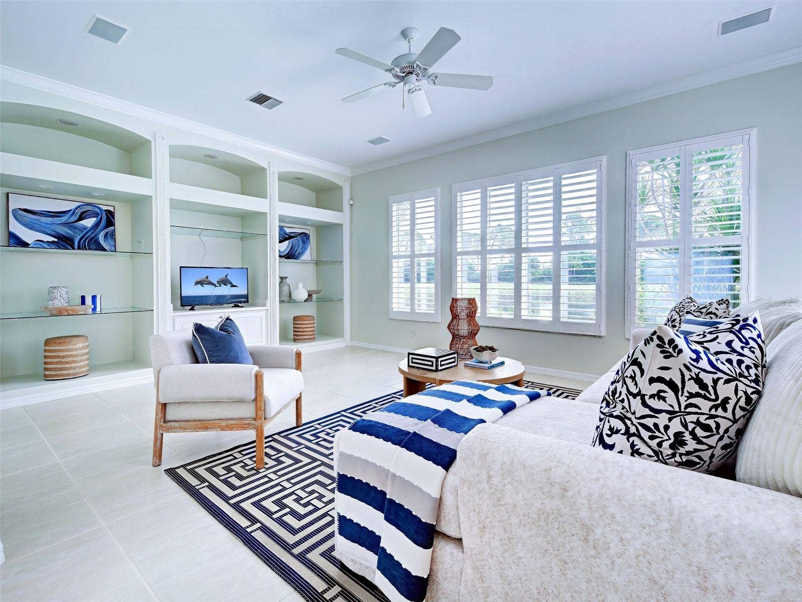 Family room has high ceilings and a wall of windows so you take in the views,
