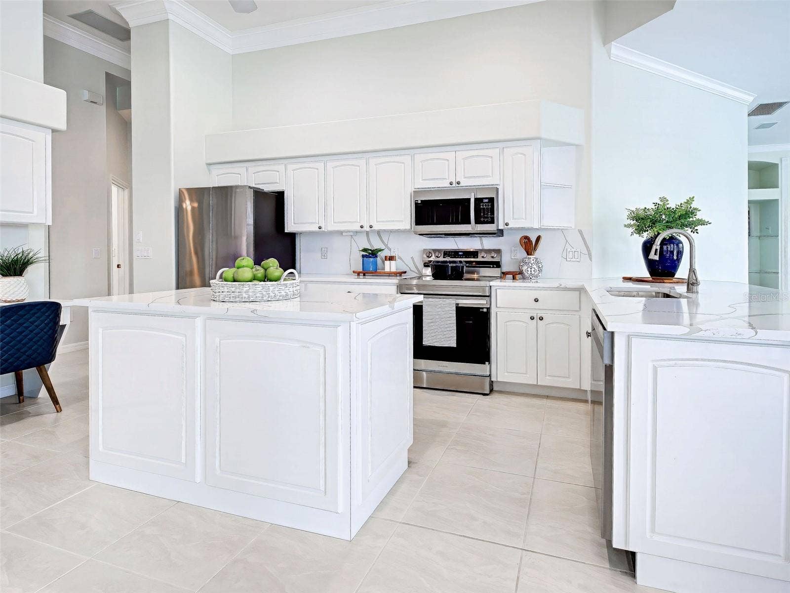 Professionally remodeled kitchen will thrill the cook thanks to the prep island and stunning quartz countertops with waterfall feature.