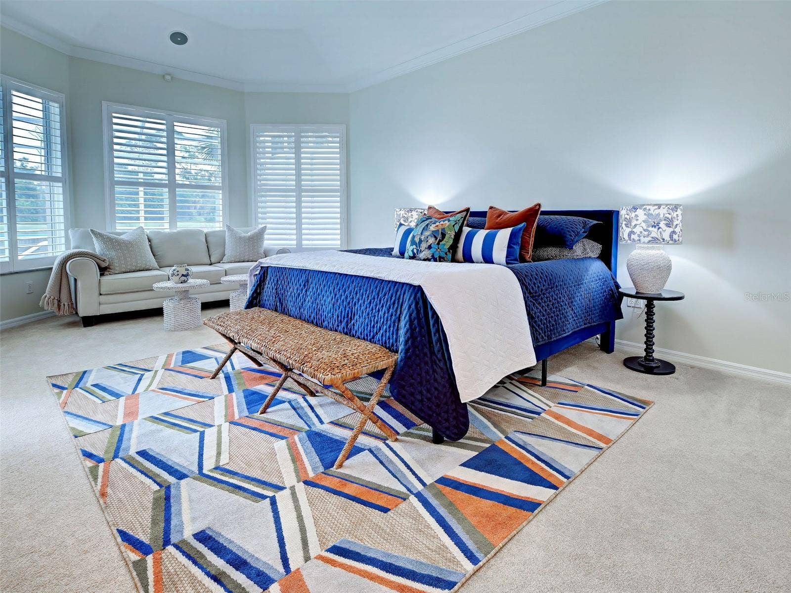 Drift off to sleep in the primary bedroom which overlooks the lake/golf course and has newer carpet and plantation shutters.