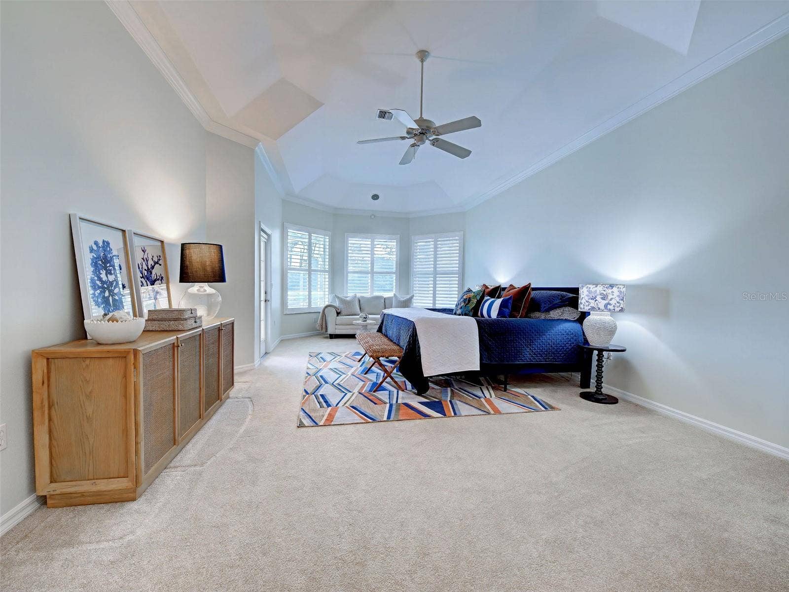 Primary bedroom is enormous and features tray ceilings and door for easy access to the lanai.