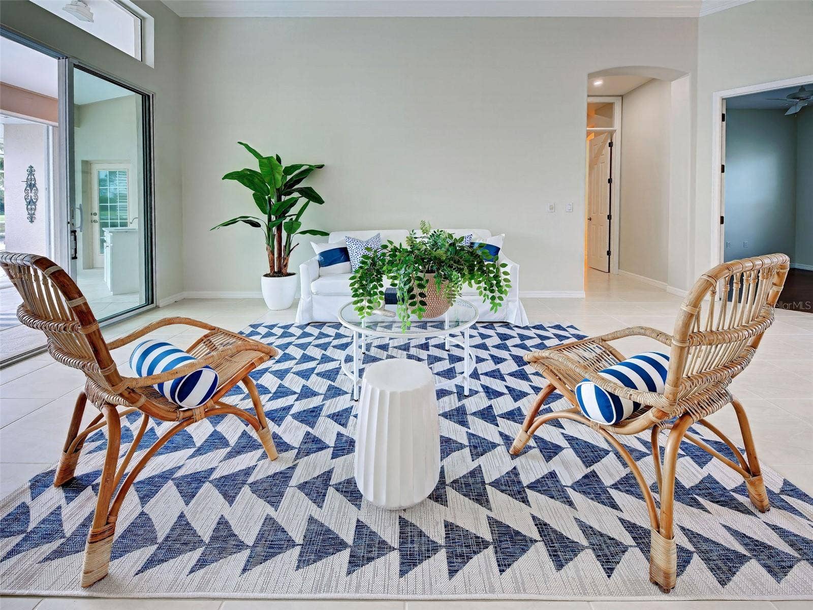 Entertain in style in the large living room which seamlessly flows to the lanai and pool area.