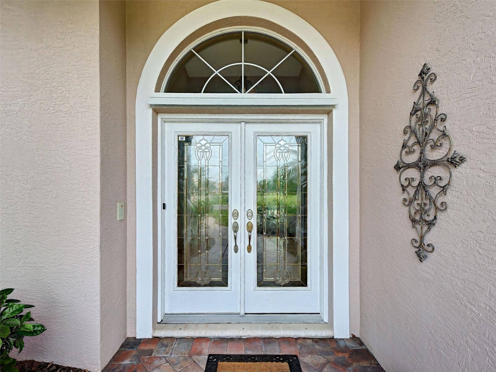 Semi-custom J & J built home makes such an impact with its paver path, lead double doors and gracious entryway.