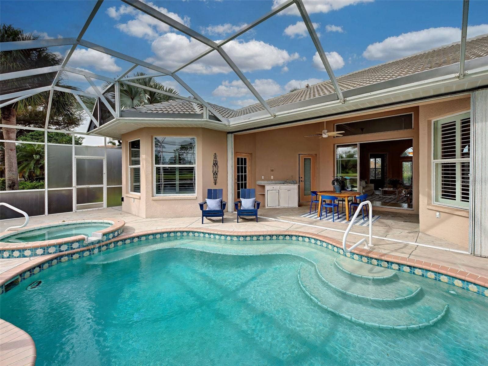 Over-sized lanai with large covered area and accordion hurricane shutters for peace of mind.