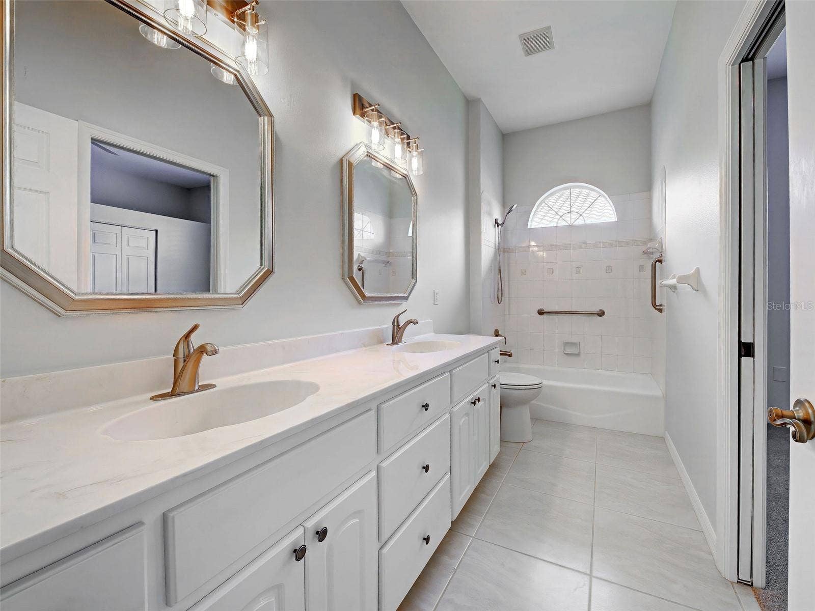 2nd bedroom's ensuite bathroom is so roomy with dual sinks and so much storage space.