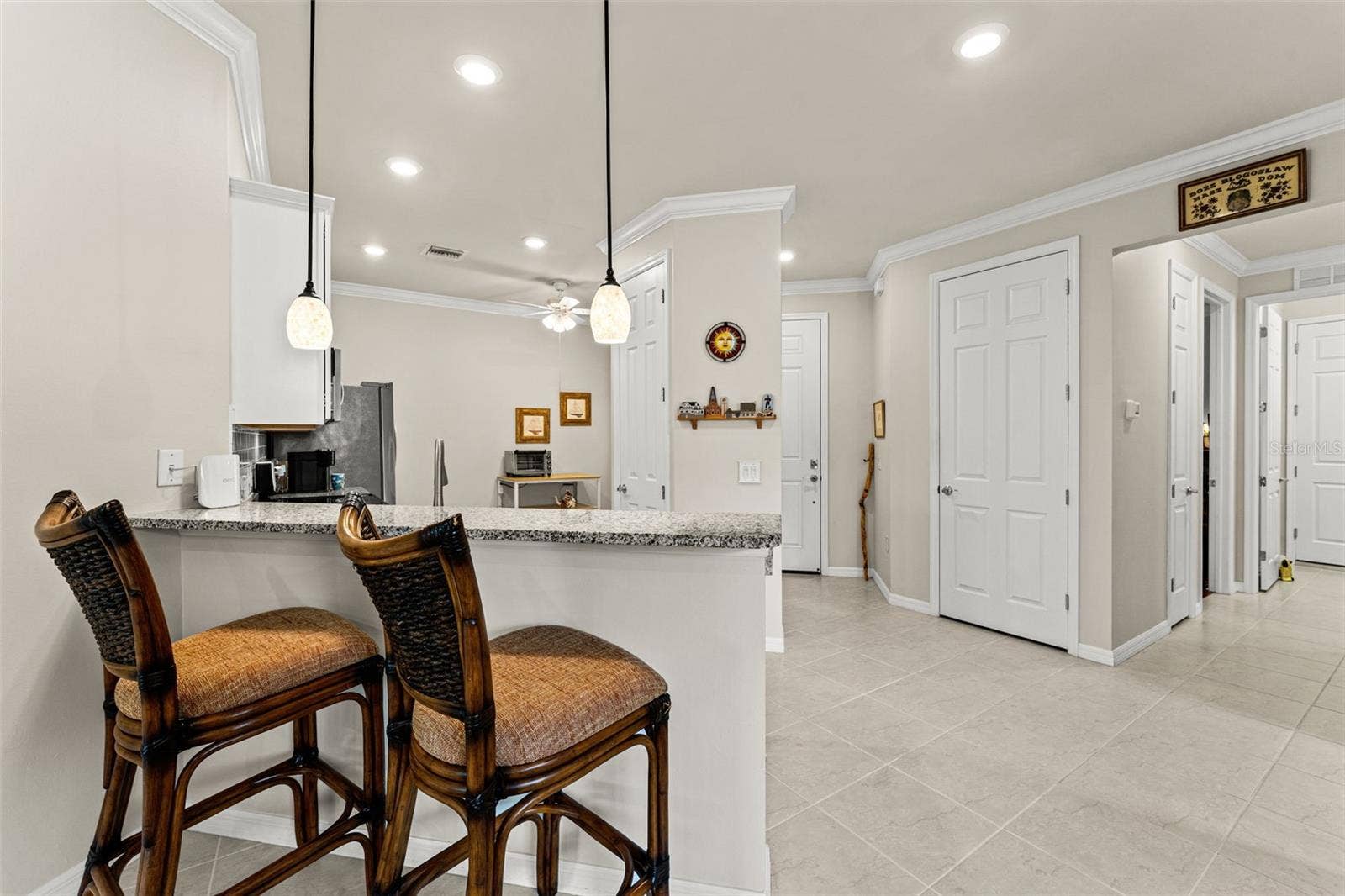 To the right is hallway to guest bed and bath, laundry and garage