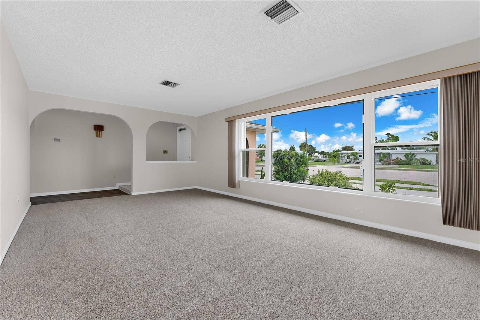 Living room view 2. All new carpeting in the living, dining and all three bedrooms.